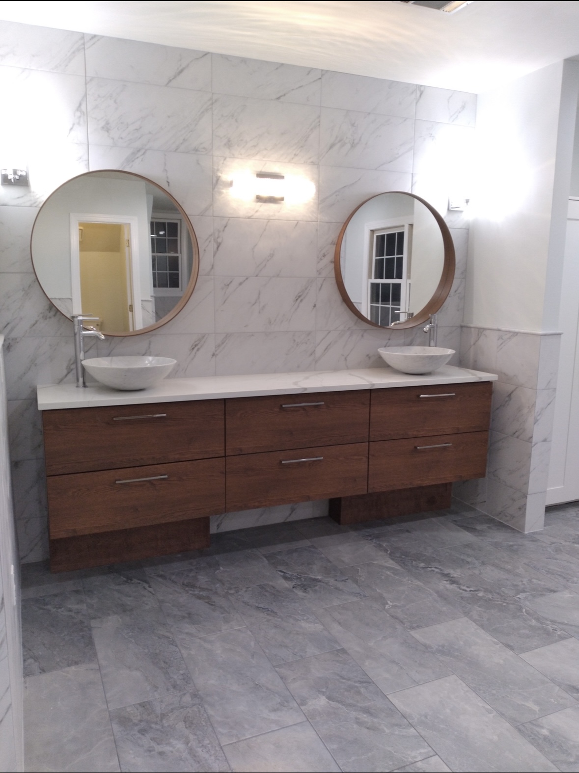 Floating vanity with round mirrors